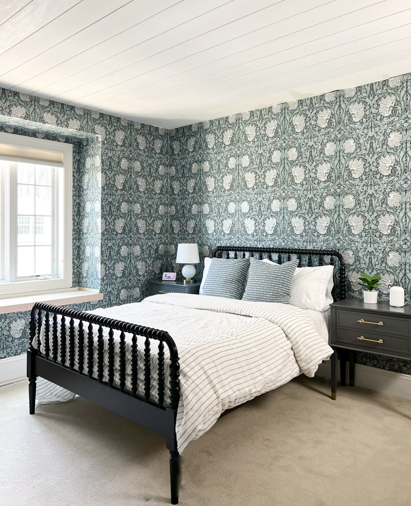 blue wallpaper in girls bedroom with black bed